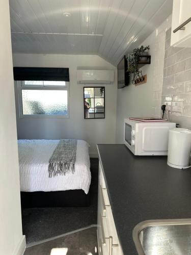 a small kitchen with a bed and a sink at The West Wing in Bournemouth