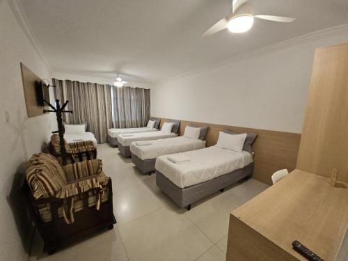 a living room with two beds and a couch at Hospedaria Santiago in Teresópolis