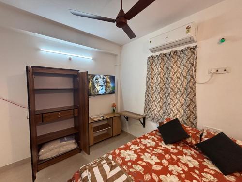 a bedroom with a bed and a ceiling fan at SHI's Agam Bed & Breakfast at Chennai in Chennai