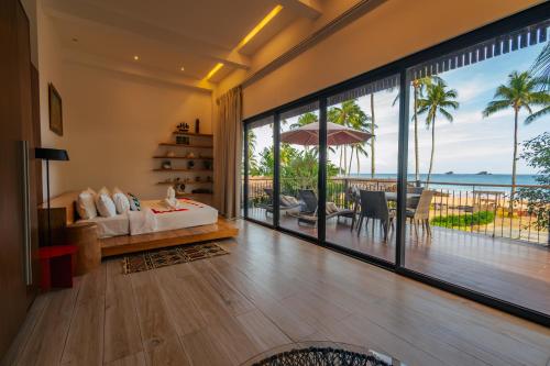 a bedroom with a bed and a view of the ocean at Nacpan Beach Glamping Managed by H Hospitality Group in El Nido