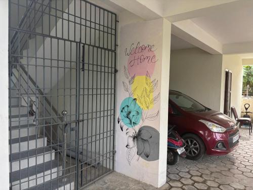a car parked in a garage with a painting on the wall at SHI's Agam Bed & Breakfast at Chennai in Chennai