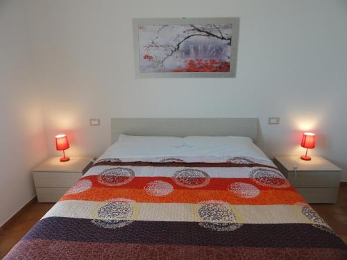 a bedroom with a bed with two lamps on both sides at Poggio Novello in Peccioli