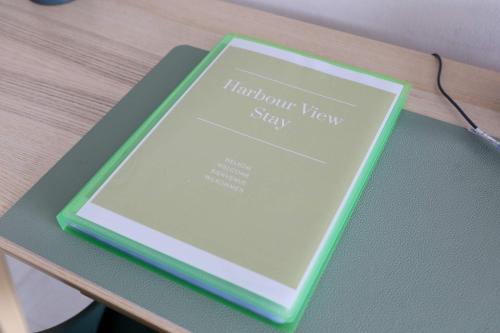 a book sitting on top of a table at Harbour View Stay - Stylish apartment with stunning views in the marina of Zeebrugge in Zeebrugge