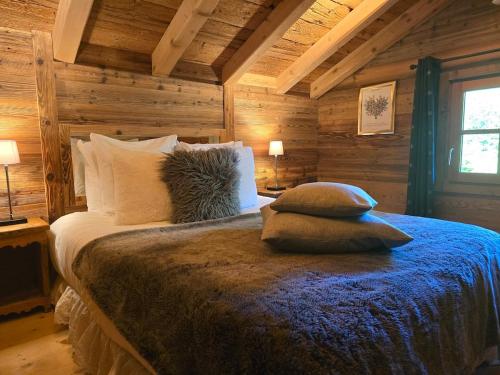 a bedroom with a bed with pillows on it at Le Mazot in Megève