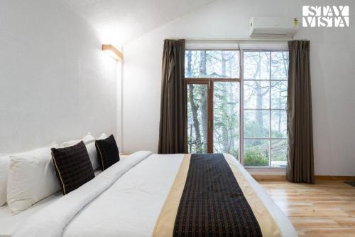 Postel nebo postele na pokoji v ubytování StayVista at Nirvana Dhar
