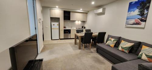 a living room with a couch and a table at Two bedroom apartment with views in Cheltenham in Cheltenham