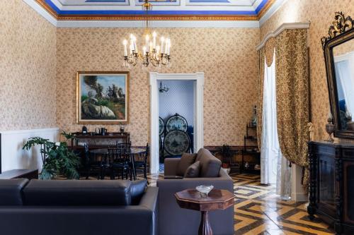 a living room with a couch and a table at Palazzo Giangreco Luxury Rooms in Avola