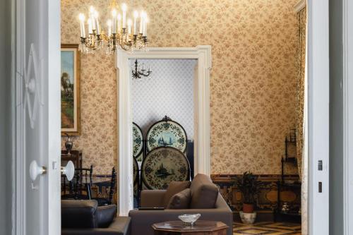 a living room with a couch and a mirror at Palazzo Giangreco Luxury Rooms in Avola