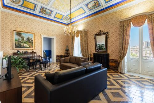 a living room with a couch and a table at Palazzo Giangreco Luxury Rooms in Avola
