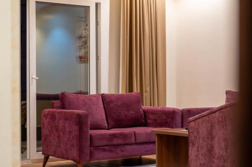 a living room with a purple couch and a table at مسكن نال in Abha