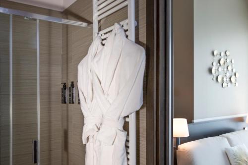 a robe hanging in a shower in a hotel room at The One Hotel - Designed for Adults - Pet lovers in Riccione