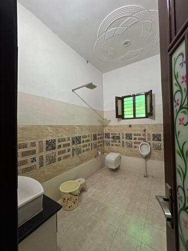 a bathroom with a toilet and a sink at Little Haven Haveli - Luxury Heritage Homestay in Bikaner