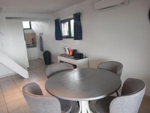 a dining room with a table and chairs at Lake best view - Amiral 21 in Erpion