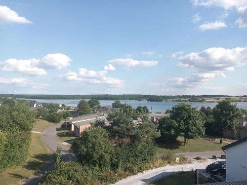 a view of a river and a town with trees at Lake best view - Amiral 21 in Erpion
