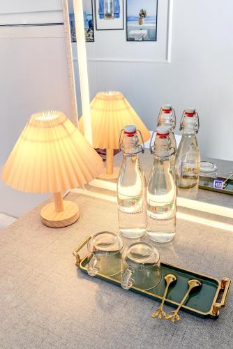 a tray with glasses and bottles on top of a counter at Rainbow Beach Mũi Né - Homestay & Coffee in Ấp Khánh Phước (1)