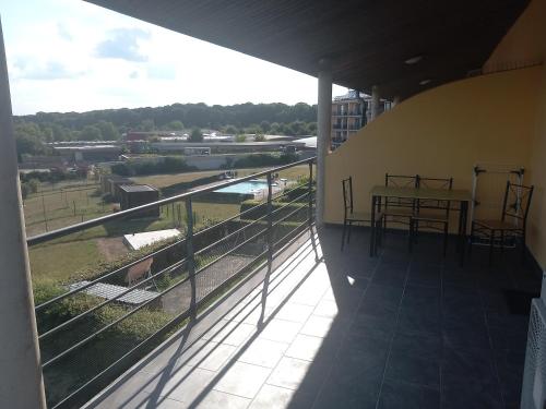 a balcony with a table and a view of a river at Lake best view - Amiral 21 in Erpion
