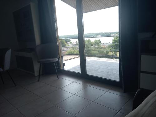 a room with a window with a view of a balcony at Lake best view - Amiral 21 in Erpion
