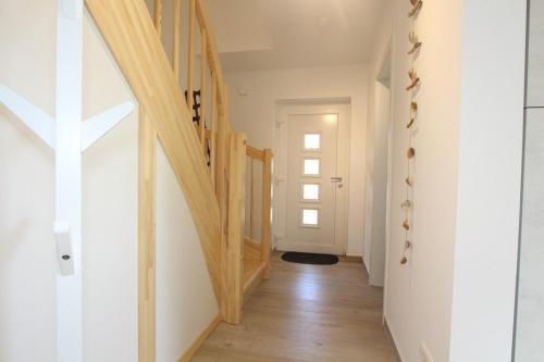 a hallway with wooden stairs in a house at Ferienhaus Skanhuus in Klütz