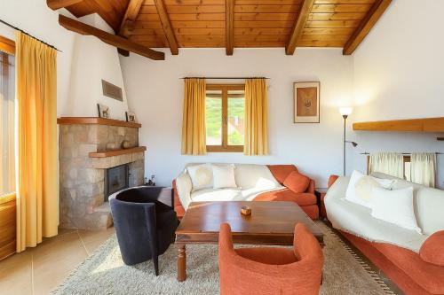 a living room with a couch and a table at Livadi Hideway Chalet by Ski Alure in Arachova