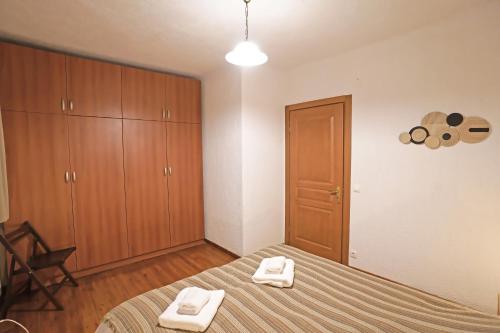 a bedroom with a bed with two towels on it at Livadi Hideway Chalet by Ski Alure in Arachova