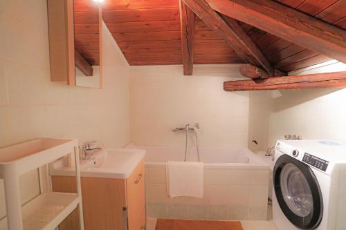 a bathroom with a washing machine and a washer at Livadi Hideway Chalet by Ski Alure in Arachova