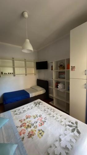 a bedroom with a bed with a white blanket at B&B Villa Pina in Colleferro