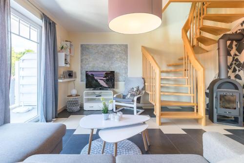 a living room with a staircase and a fireplace at Ferienwohnung Seeigel in Tarnewitz