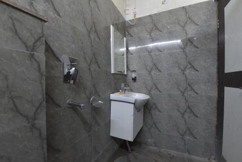 a bathroom with a sink and a shower at Hotel Atyant Shubh in Dehradun