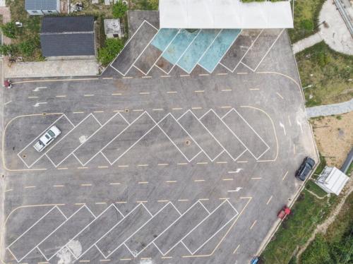 an aerial view of a parking lot with a crosswalk at Shanyin Xijiang Rustic Luxury Resort Hotel in Bailian