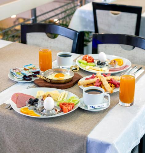 a table with eggs and breakfast foods on it at OTEL KÂYA in Izmir