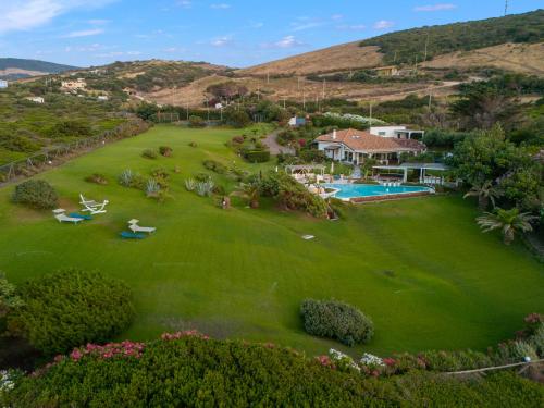 an aerial view of a house with a large green yard at Villa Ambra 10, Emma Villas in Sorso