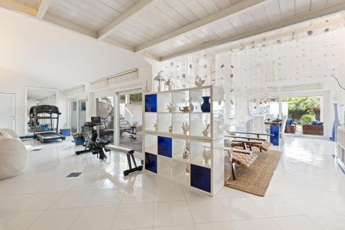 a large room with a gym with a fitness center at Villa Ambra 10, Emma Villas in Sorso