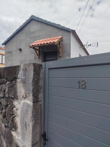 a garage door in front of a house at Bragada Stonehouse in São Roque do Pico