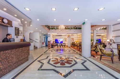 a man sitting at a bar in a restaurant at OTEL KÂYA in Izmir