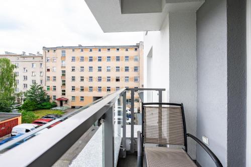 a balcony of a building with a bench on it at Comfort Apartments Batorego in Gdynia
