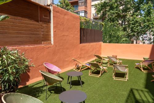 a group of chairs and tables on a lawn at htop BCN City #htopEnjoy in Barcelona
