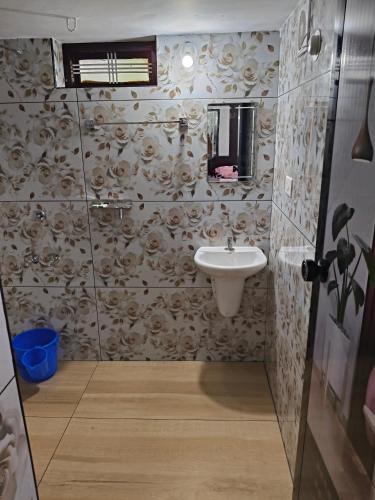 a bathroom with a sink and a mirror at UD- VAS home stay in Varkala
