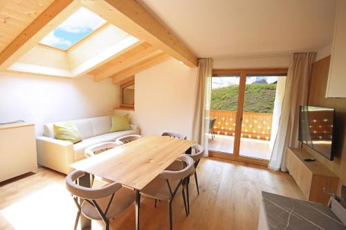 a living room with a table and a couch at Aurturist Sesto in Sesto