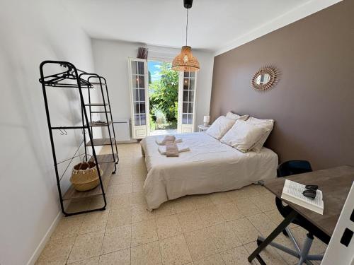 a bedroom with a bed with a ladder and a table at La Douce Parenthèse in Talence