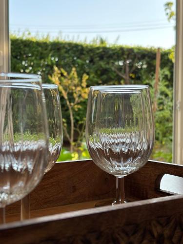 two empty wine glasses sitting on a ledge at La Douce Parenthèse in Talence