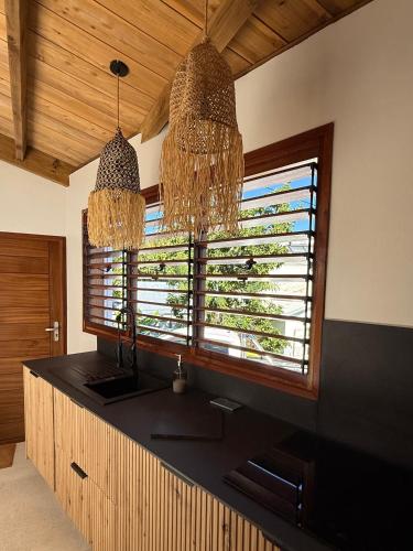 a kitchen with a sink and a large window at La Kaz Banian in Saint-Pierre