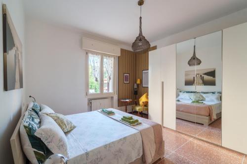 a bedroom with a bed and a mirror at Casa Alderotti in Bologna