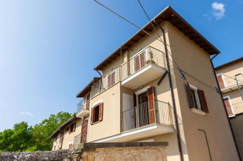 a building with balconies on the side of it at Casa Belvedere - Affitti Brevi Italia in Poggio Picenze
