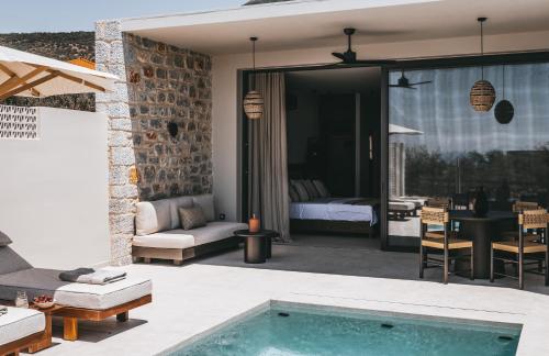 a house with a swimming pool and a bedroom at Castor & Pollux in Kotrónion