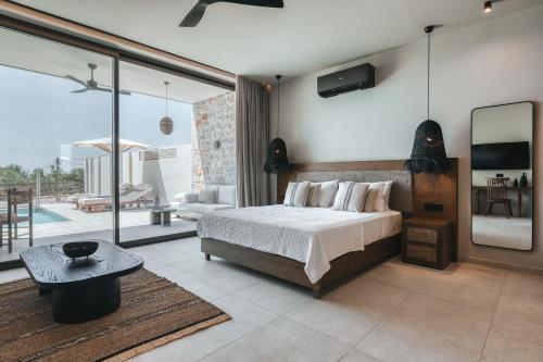 a bedroom with a bed and a view of a patio at Castor & Pollux in Kotrónion