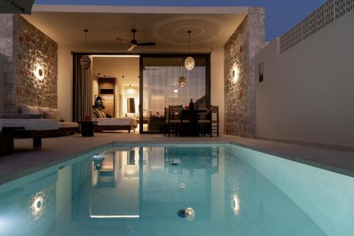 a swimming pool in a living room with at Castor & Pollux in Kotrónion