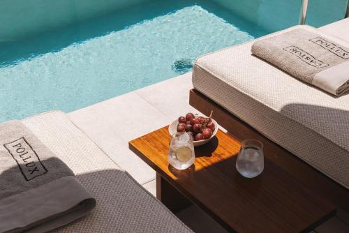 a bowl of fruit on a table next to a pool at Castor & Pollux in Kotrónion