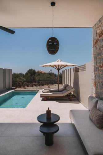 a living room with a couch and a swimming pool at Castor & Pollux in Kotrónion