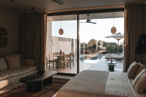 a living room with a couch and a view of a pool at Castor & Pollux in Kotrónion
