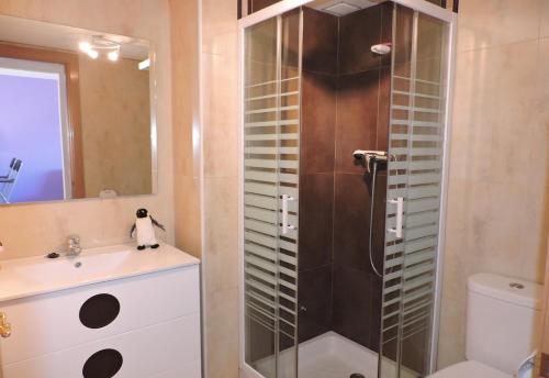 a bathroom with a shower with a sink and a toilet at Lcd - Maricel in Miami Platja